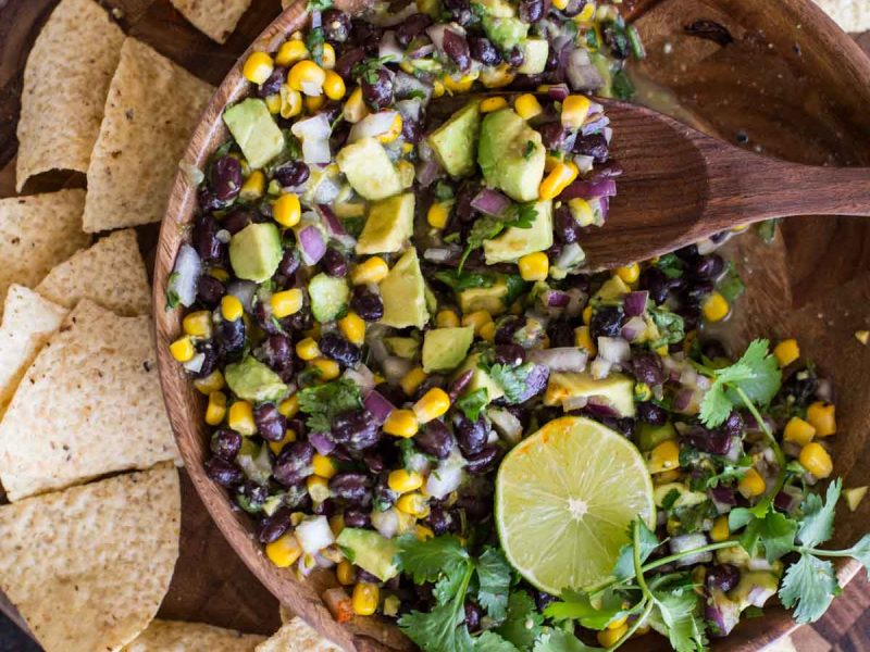 Quick and easy Avocado Dip! Everyone LOVES this fresh mix of avocado, black beans, and corn!