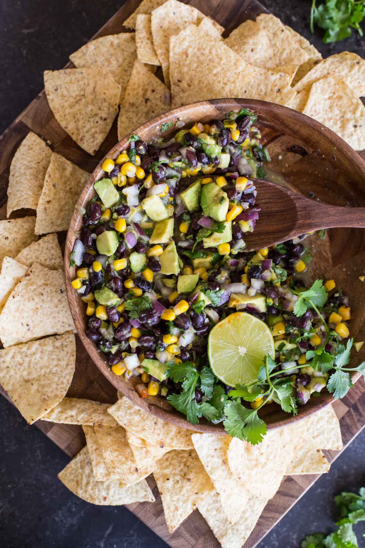 Quick and easy Avocado Dip! Everyone LOVES this fresh mix of avocado, black beans, and corn!
