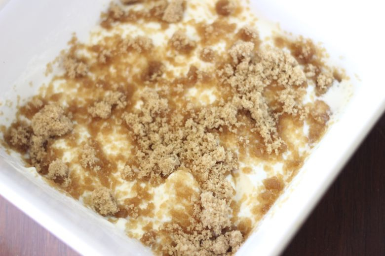 Yogurt cream with brown sugar on top in a bowl.