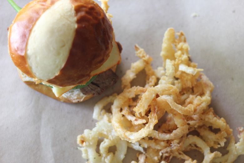 Steak Sandwich with Onion Straws next to it.