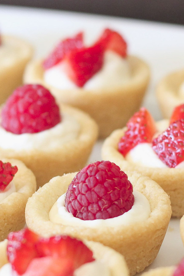 Sugar cookie tarts filled with sweetened cream cheese and topped with berries.