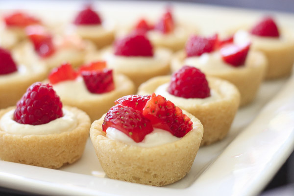 Sugar cookie tarts filled with sweetened cream cheese and topped with berries.