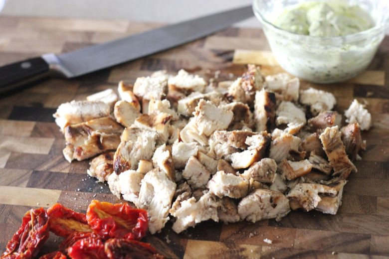 Sun-Dried Tomato Pesto Rotini ingredients on a cutting board.  