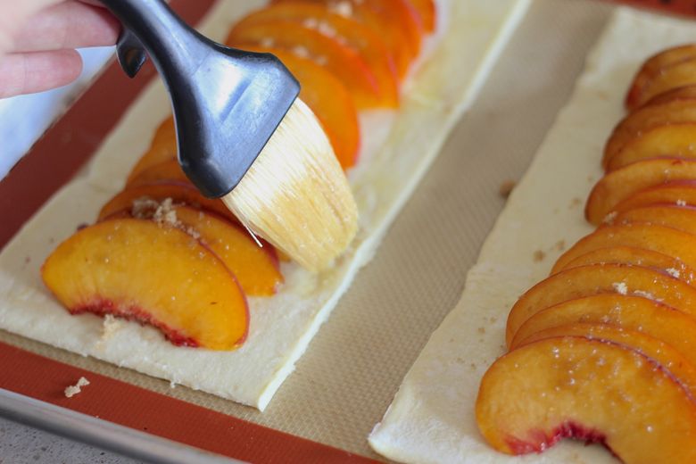 Egg wash brushed on edges of assembled Peach Tart before baking.