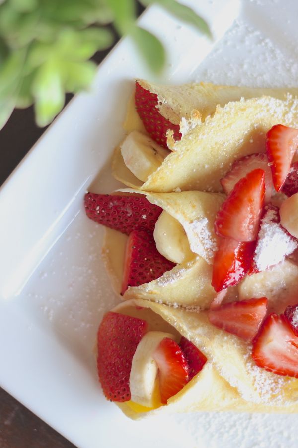 Strawberry Banana Crepes on a plate.  