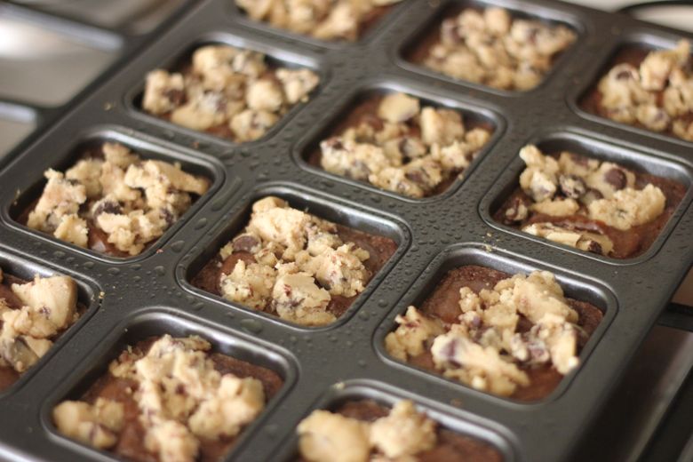 Triple Layer Brownie pan with chocolate chip cookie dough crumbles on top of partially cooked brownies.  