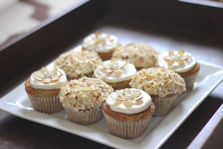 Zucchini Almond Cupcakes decorated and displayed on a platter. 