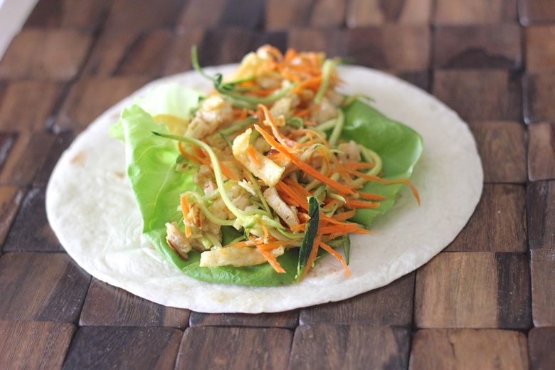 Asian Chicken Veggie Wraps placed in a tortilla.