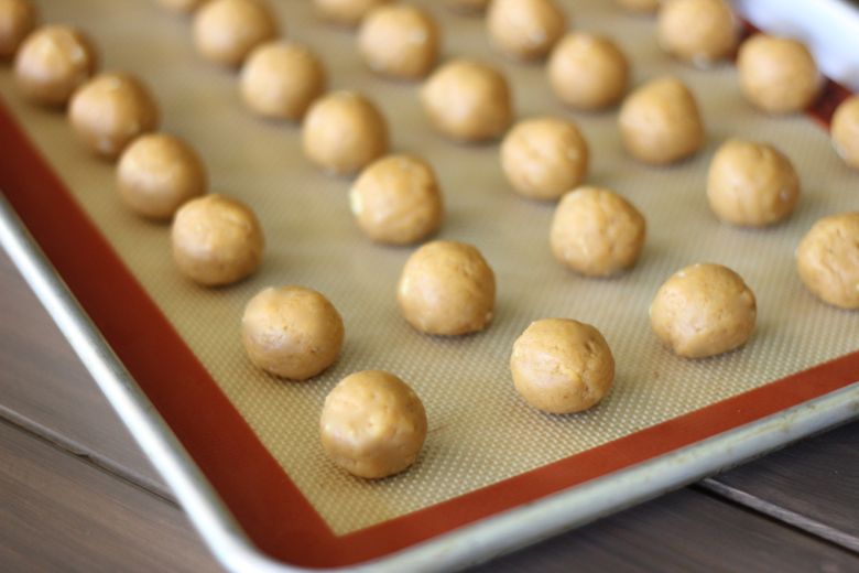 Pumpkin pie balls on a baking sheet.  