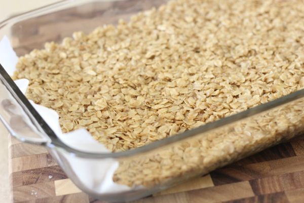 Salted Caramel Oat Bars oat layer in a glass baking dish.  