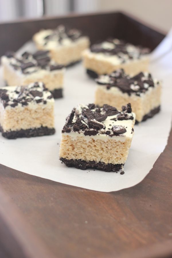 Cookies and Cream Rice Krispie Treats cut in squares on parchment paper.  