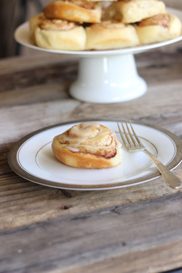 Maple Glazed Cinnamon Roll on a plate with a fork.  
