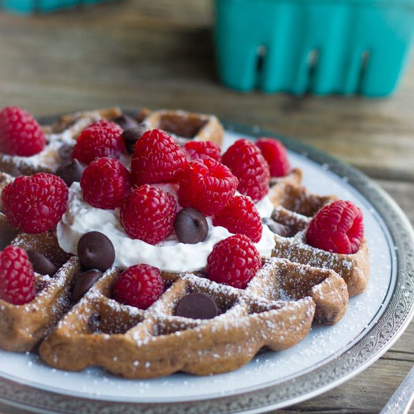 Not too sweet chocolate waffles with fresh raspberries and whipped cream!
