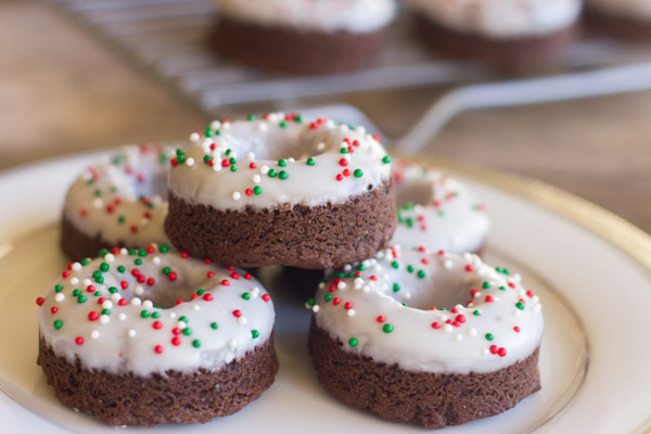 Iced Chocolate Donut Cookies - tiny bites of chewy chocolate cookie with powdered sugar icing and red and green nonpareils