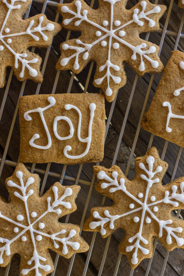 Iced Graham Cracker Snowflakes on a cooling rack.