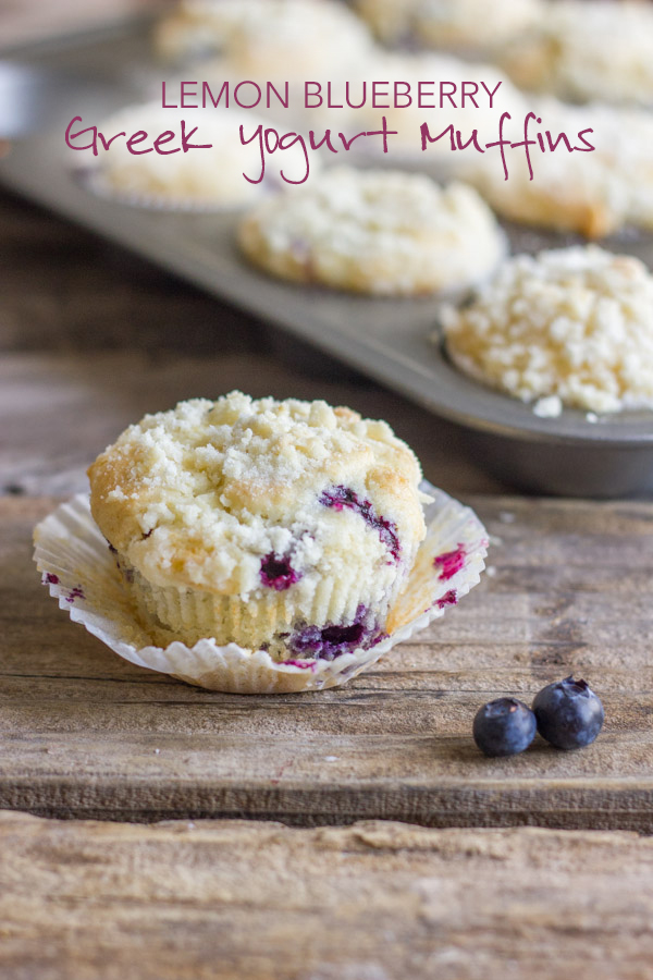 Lemon Blueberry Greek Yogurt Muffin with the muffin wrapper opened up, and a muffin tin with more Lemon Blueberry Greek Yogurt Muffins in the background.  