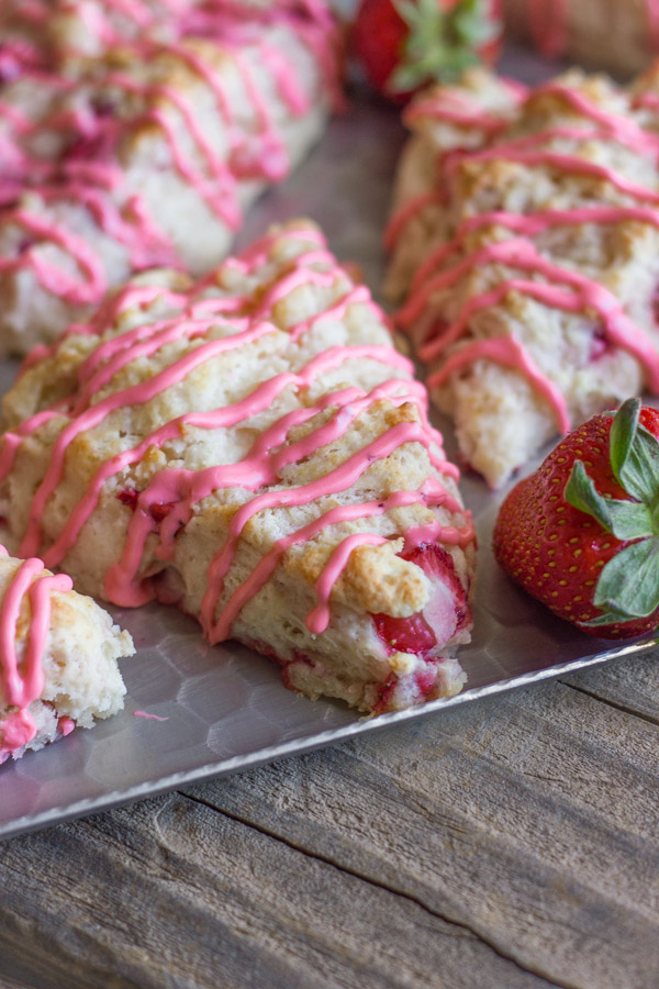 Dreamy Strawberries & Cream Scones on a serving platter with whole strawberries. 