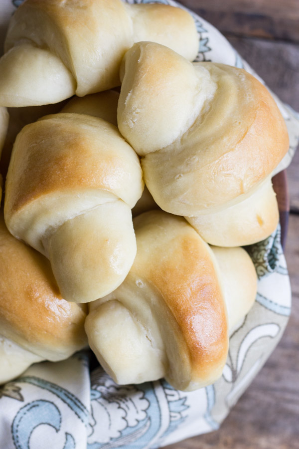 The Best Butterhorn Rolls in a cloth lined wooden bowl.  