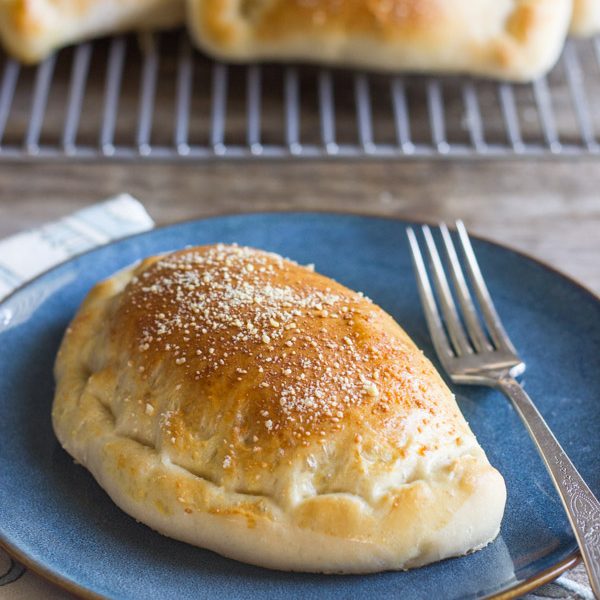 Homemade Calzones - Warm, soft pockets of pizza dough stuffed with Italian sausage, marinara, and mozzarella cheese.