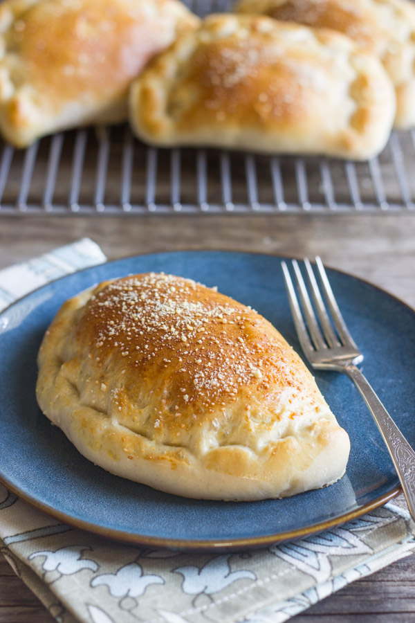 Homemade Calzones - Warm, soft pockets of pizza dough stuffed with Italian sausage, marinara, and mozzarella cheese.