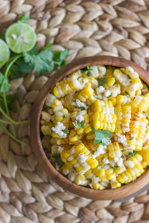 Chili Lime Sweet Corn Salad - sweet corn tossed with butter, fresh lime, chili powder, cilantro, and queso fresco. Amazing!