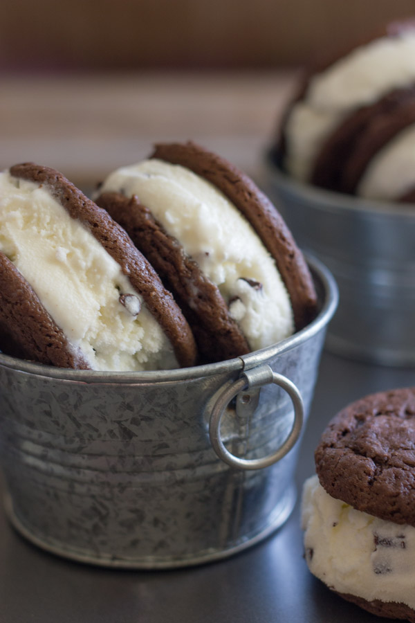 Mint Chip Oreo Ice Cream Sandwiches in galvanized buckets and one Mint Chip Oreo Ice Cream Sandwich next to the bucket.