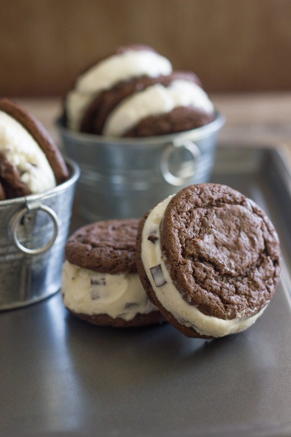 Mint Chip Oreo Ice Cream Sandwiches on a tray, with Mint Chip Oreo Ice Cream Sandwiches in galvanized buckets in the background.