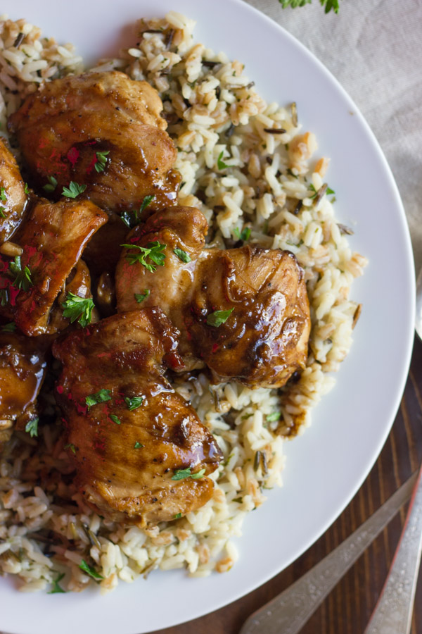 Creamy Balsamic Skillet Chicken served over rice on a plate.