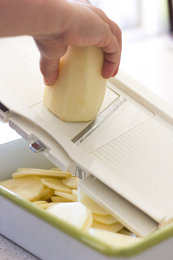 Slicing a potato with a mandoline.