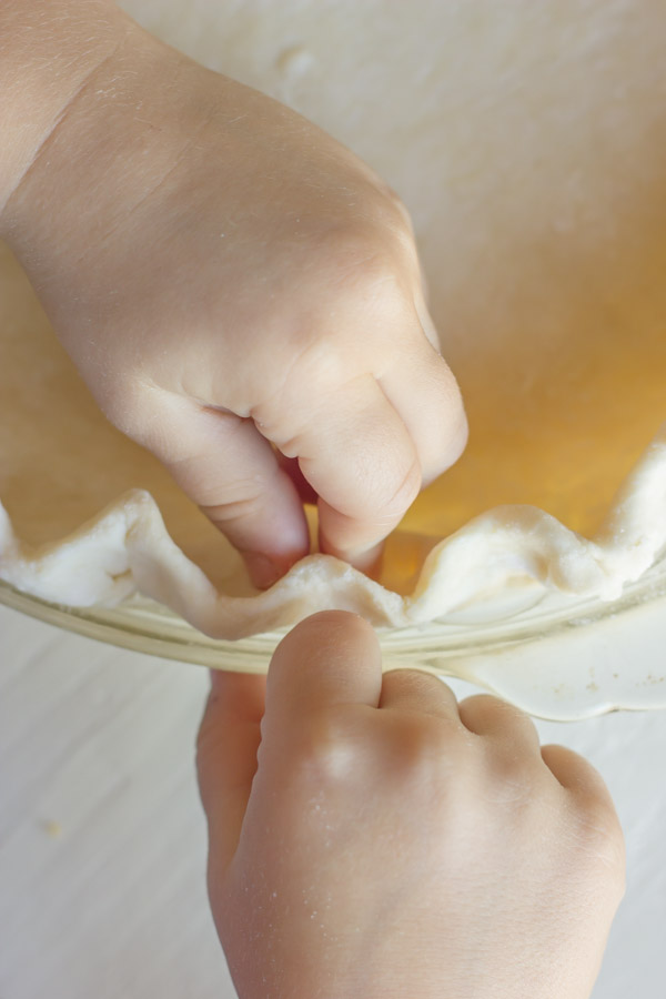 Pie Crust Tutorial Step 7 - crimping the edges of the pie dough.
