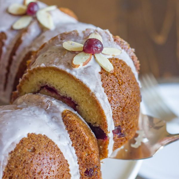 Cranberry Almond Greek Yogurt Cake - Sweet, moist almond cake laced with cranberry sauce and topped with an almond glaze.