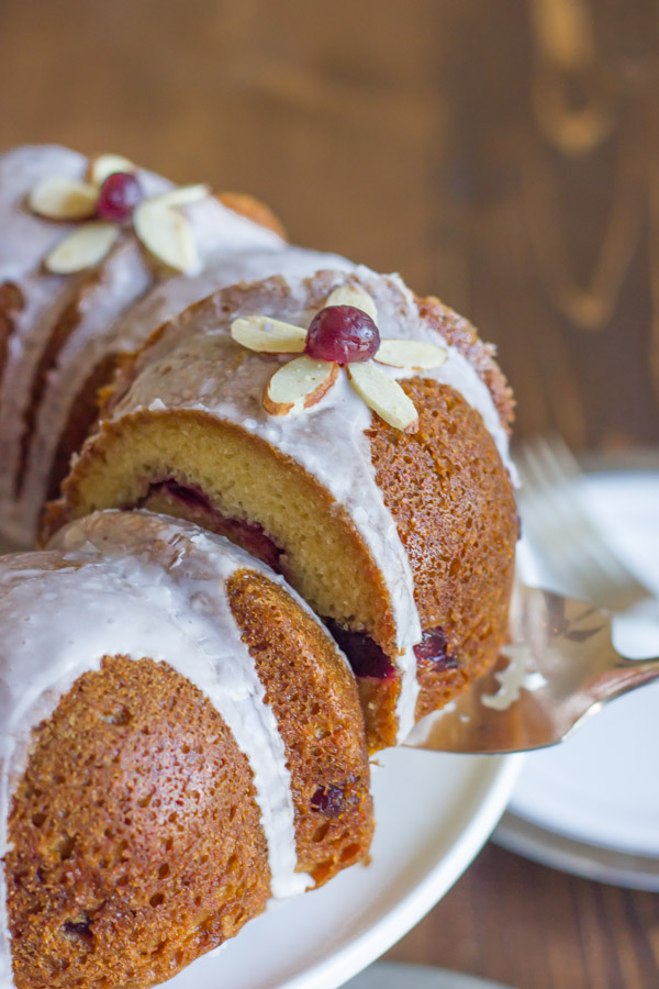 Cranberry Almond Greek Yogurt Cake - Sweet, moist almond cake laced with cranberry sauce and topped with an almond glaze.