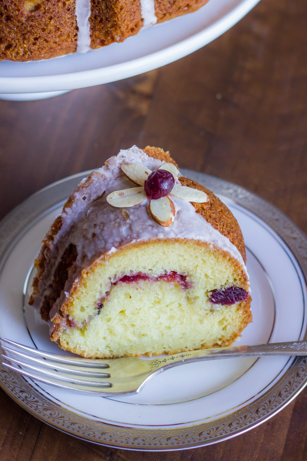 Cranberry Almond Greek Yogurt Cake slice on a plate with a fork.  