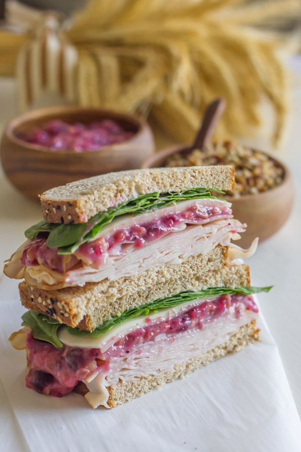 Turkey And Cranberry Sandwich cut in half, with the halves stacked on top of each other.