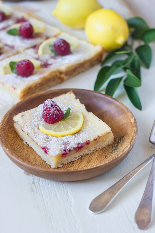 Raspberry Lemon Bars - fresh raspberries whisked into a sweet and tart lemon filling - all on top of a thick, buttery shortbread crust!