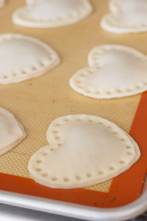 Strawberry Pie Hearts on a Silpat lined baking sheet before baking them.  