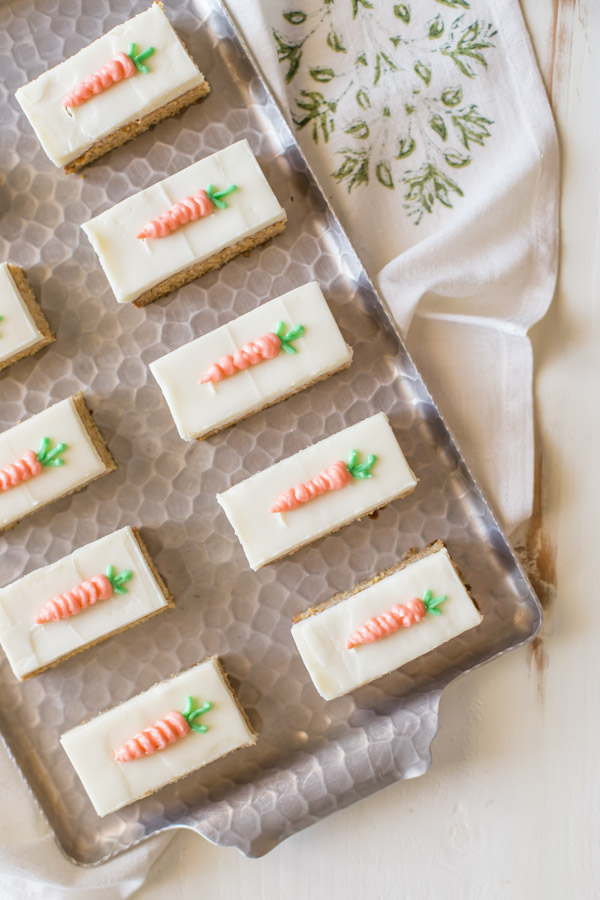Carrot Cake Bars with Cream Cheese Frosting arranged on a serving tray. 