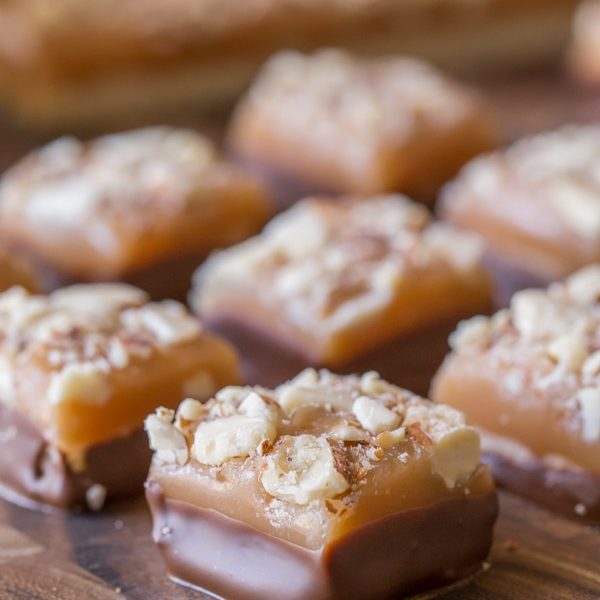 Homemade Caramel Almond Shortbread Bites - Tiny pieces of chocolate covered shortbread topped with the best ever homemade caramel and almonds!
