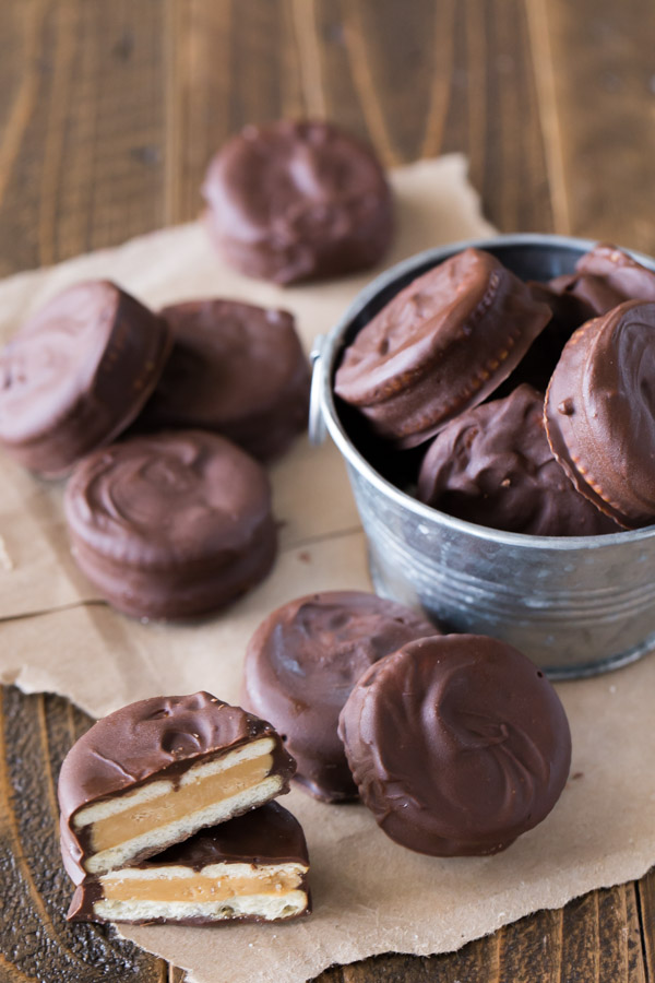 Peanut Butter Buckeye Cookie cut in half and stacked, with more cookies around it and in a small galvanized bucket.  