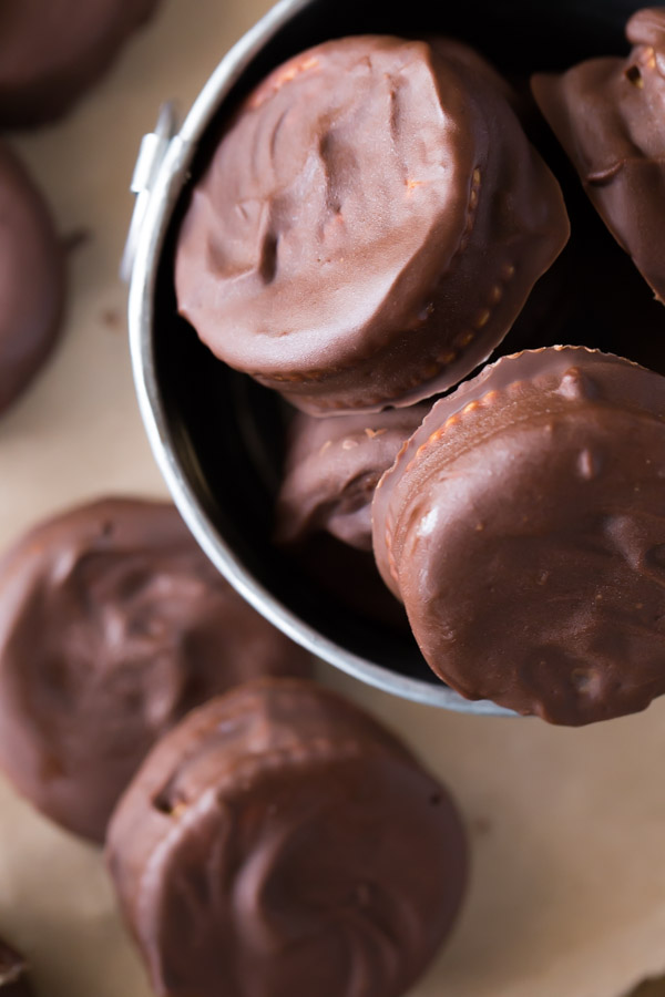 Peanut Butter Buckeye Cookies in a small galvanized bucket, with more cookies around the bucket.  