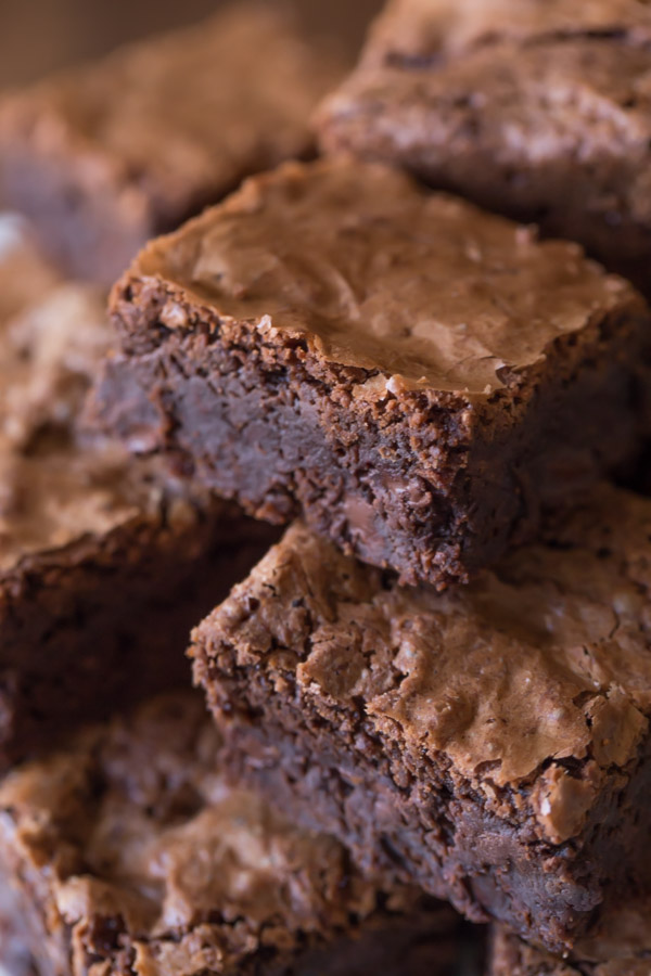 Extra Thick Fudgy Homemade Brownies cut in squares and stacked in a pile.  