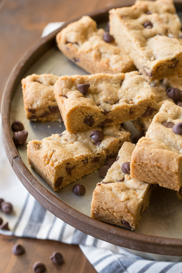 Peanut Butter Chocolate Chip Cookie Bars arranged on a cake stand.  