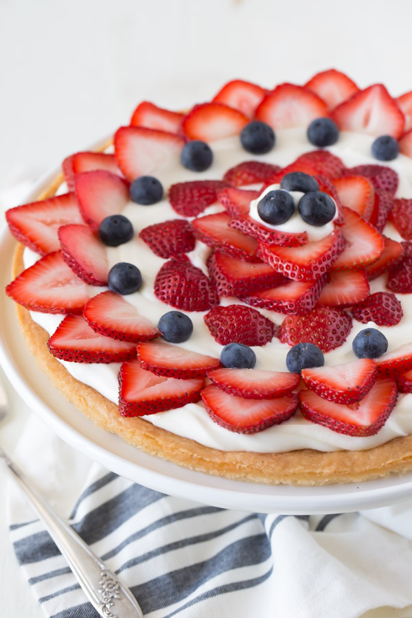Strawberry Cream Cheese Tart on a cake stand.  