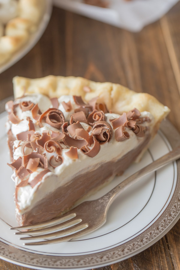 Homemade Chocolate Pudding Pie slice on a plate with a fork.  