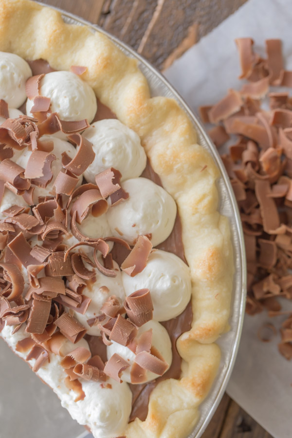 Homemade Chocolate Pudding Pie with some milk chocolate curls next to it.  