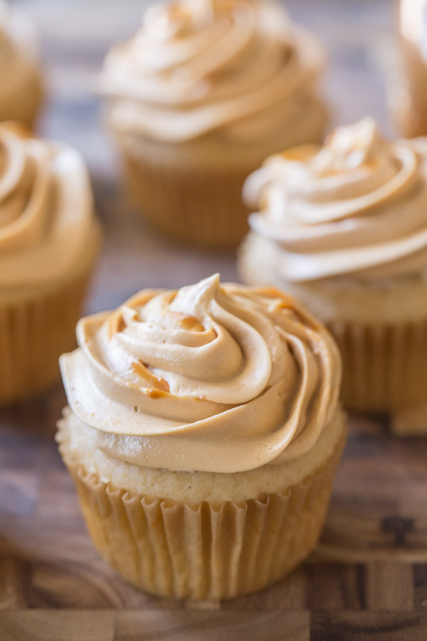 Apple Cupcake With Dulce De Leche Buttercream, with more cupcakes in the background. 