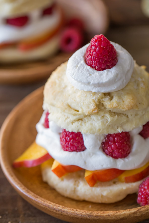 Raspberry Peach Shortcake assembled on a wood plate. 