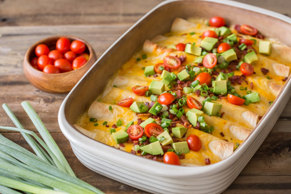 Breakfast Enchilada Bake - A super hearty, ultimate breakfast enchilada bake filled with eggs and cheese that can be served any time of the day.