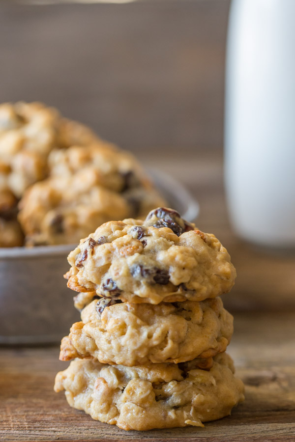 Healthy Breakfast Cookies stacked in a pile of three, with more cookies and milk in the background.  