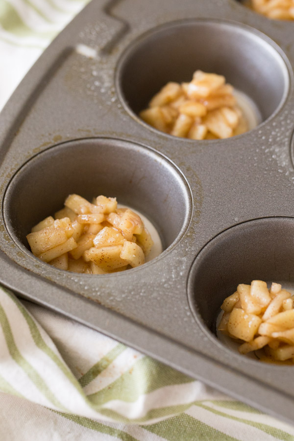 Muffin wells with pie dough and cinnamon apple filling for the Dutch Apple Pie Cookies.